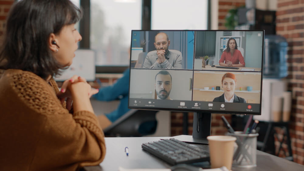 A person participating in a video conference call on a computer.